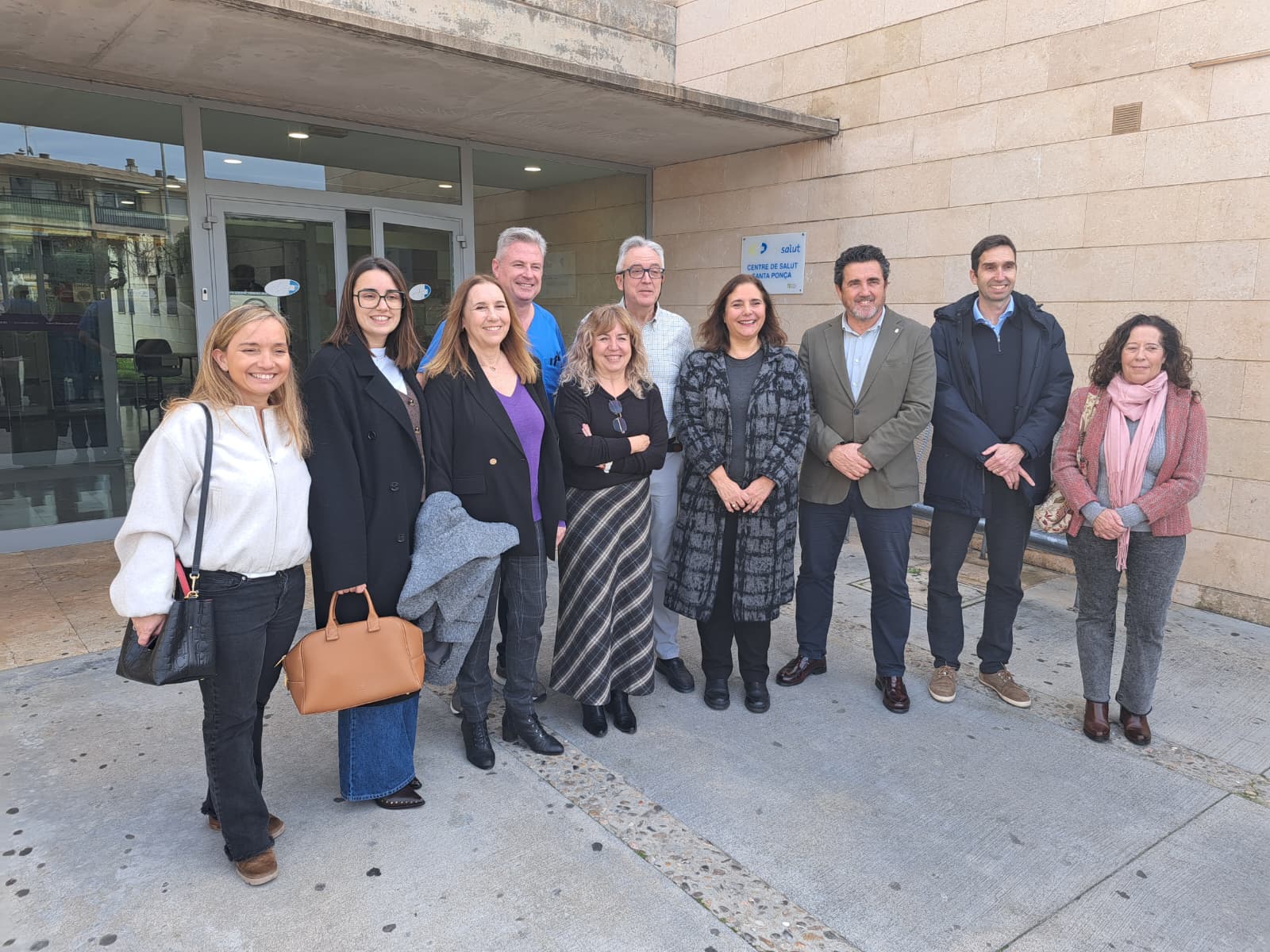 ​​La consellera de Salut, Manuela García, a la porta d'accés del Centre de Salut Santa Ponça amb altres representants de la Conselleria i l'equip directiu del centre. 